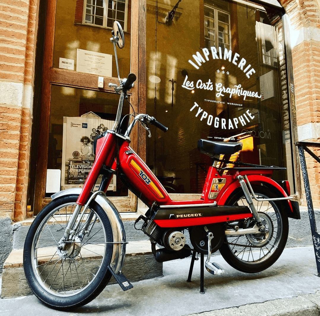 Vintage bike in front of typography shop